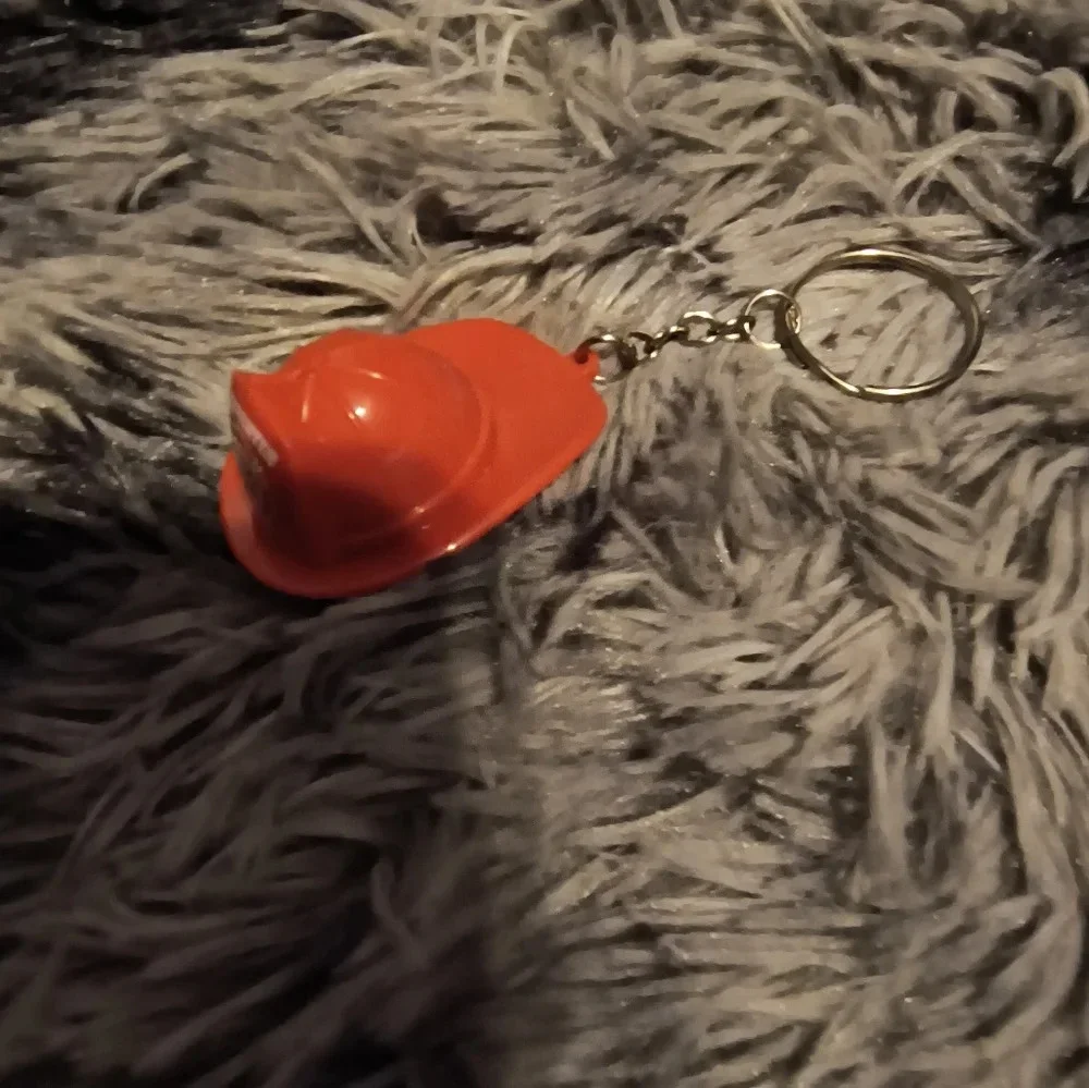 Red and white fireman’s hat keychain with light